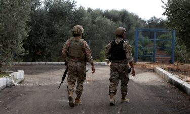 Members of the Lebanese army walk in the village of Dhayra