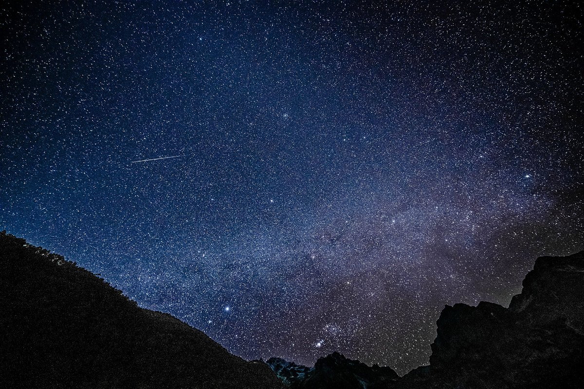 A Geminid meteor is seen streaking across the sky at the Yulong Snow Mountain in southwest China in 2021. This year, the Geminids will peak on Thursday.