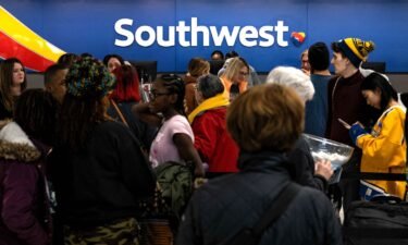 Travelers wait in line at the Southwest Airlines ticketing counter at Nashville International Airport after the airline canceled thousands of flights in Nashville