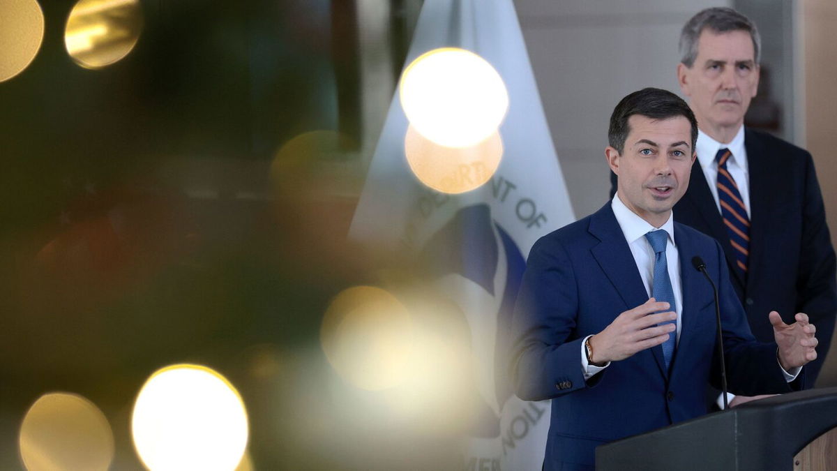 <i>Win McNamee/Getty Images</i><br/>Transportation Secretary Pete Buttigieg (L) and FAA Administrator Mike Whitaker speak during a news conference at Ronald Reagan National Airport December 19