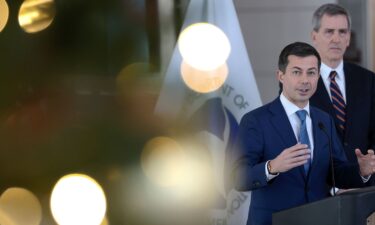 Transportation Secretary Pete Buttigieg (L) and FAA Administrator Mike Whitaker speak during a news conference at Ronald Reagan National Airport December 19