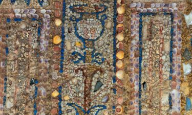 The 2300-year-old shell grotto was used as an outdoor dining room and features a sizeable wall mosaic featuring brightly colored shells