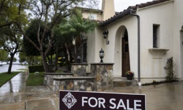 A for sale sign sits outside a home in Irvine