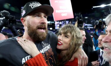 Travis Kelce #87 of the Kansas City Chiefs celebrates with Taylor Swift after a 17-10 victory against the Baltimore Ravens in the AFC Championship Game at M&T Bank Stadium on January 28