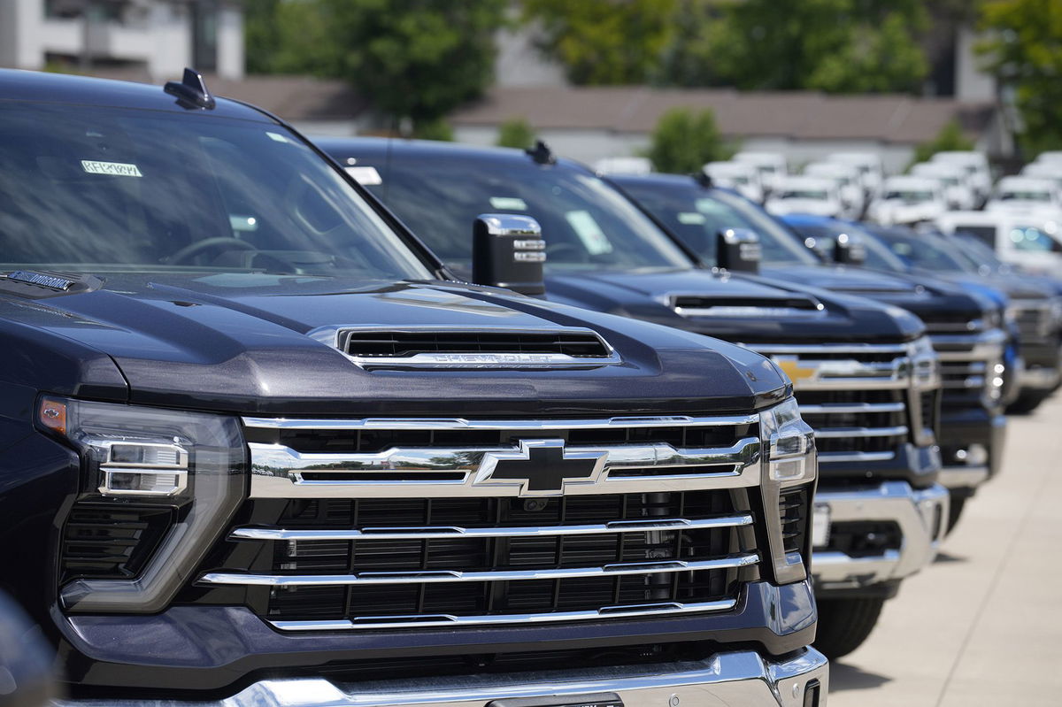 Silverado pickup trucks sit in a long row at a Chevrolet dealership in June. Fourth quarter sales of some GM vehicles, were hurt by the strike at the nation's three unionized automakers by the United Auto Workers union.