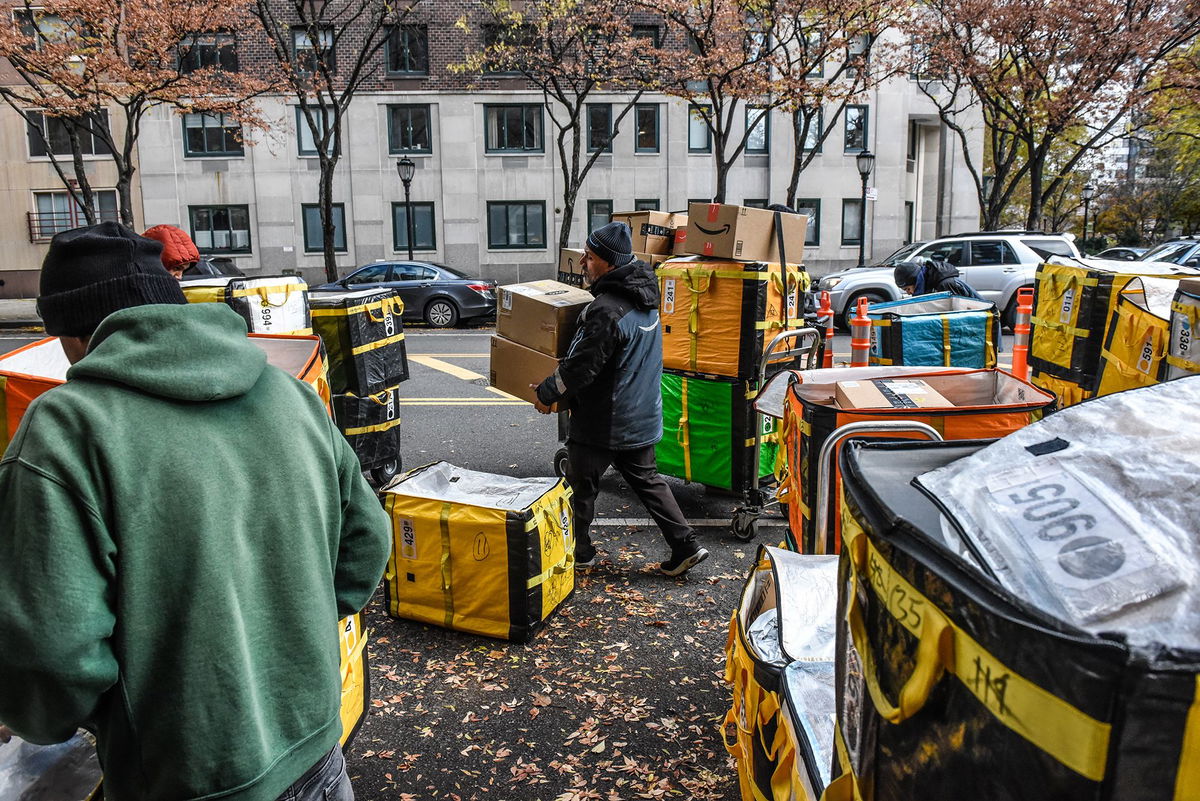 Amazon workers deliver packages on Cyber Monday in New York in November 2023. Americans spent a record $222 billion shopping online this holiday season.