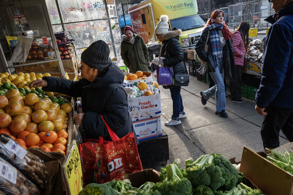 Patrons shop for produce at a Mr. Pina Market in Brooklyn, New York, on December 26. The US inflation picture greatly improved in 2023, and so have Americans’ attitudes about it.