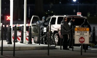 US Secret Service police investigate near a vehicle that hit a security barrier at a entry point for the White House complex