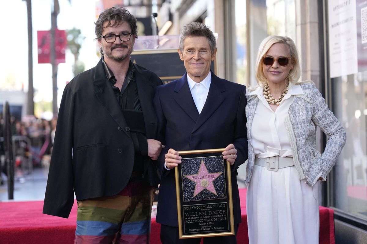 Willem Dafoe, center, stands with Pedro Pascal, left, and Patricia Arquette, right.