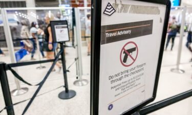 A sign at Miami International Airport warns travelers that guns are prohibited at a security checkpoint.