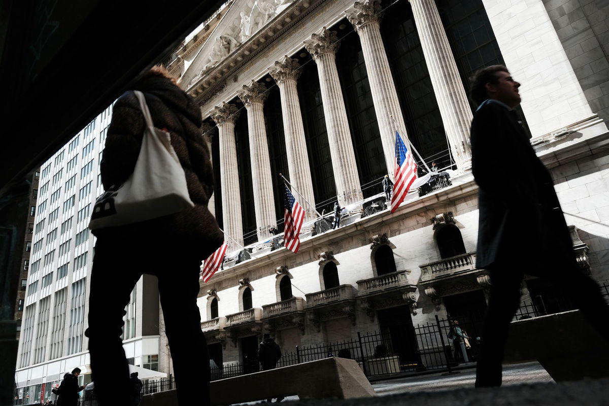 <i>Spencer Platt/Getty Images</i><br/>People walk by the New York Stock Exchange in the Financial District on March 7