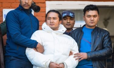 Nepal police escort Ram Bahadur Bomjam (center)