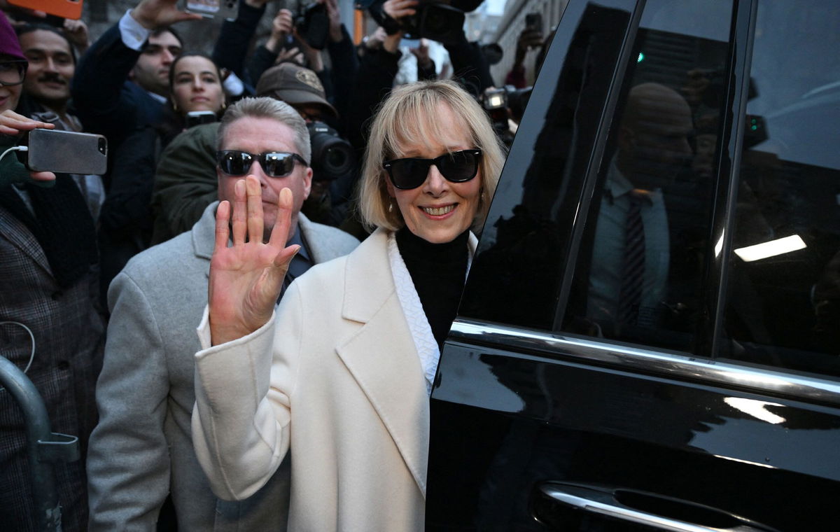 <i>Angela Weiss/AFP/Getty Images</i><br/>Writer E. Jean Carroll waves as she leaves federal court after the verdict in her defamation case against former President Donald Trump in New York on January 26.