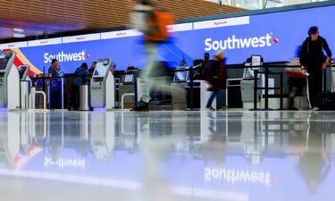 Travelers walk past the Southwest Airlines check-in counter at Denver International Airport in 2022.