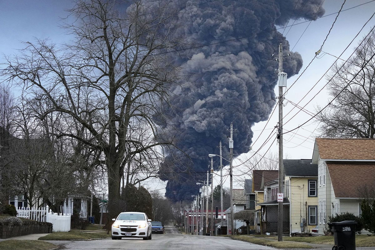 <i>Gene J. Puskar/AP</i><br/>A black plume rises over East Palestine