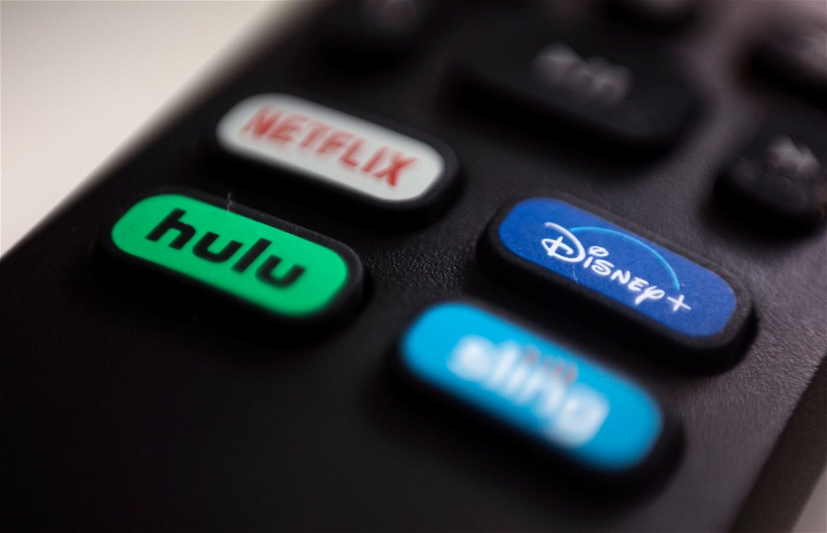 Disney+, Hulu and ESPN+ will start banning password sharing on their streaming services. Pictured are the logos of Hulu and Disney+ on a remote control.