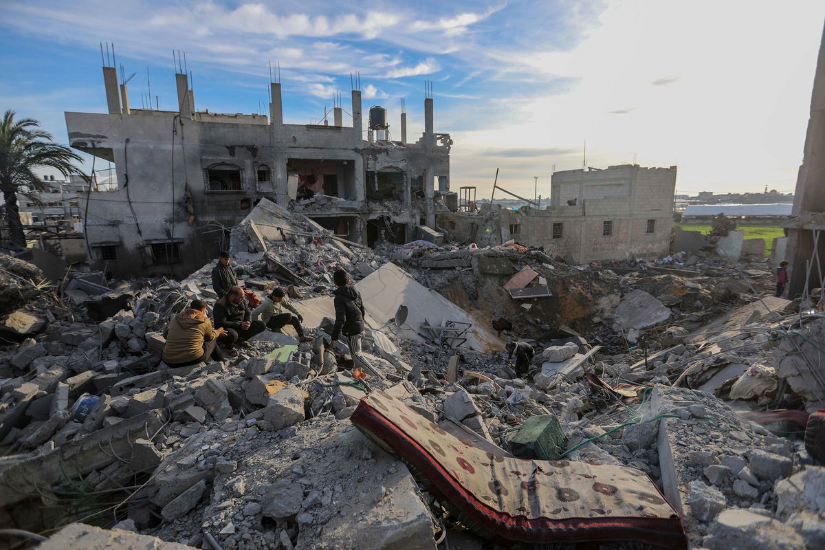 <i>Ahmad Hasaballah/Getty Images via CNN Newsource</i><br/>People inspect the damage to their homes following Israeli air strikes on February 12