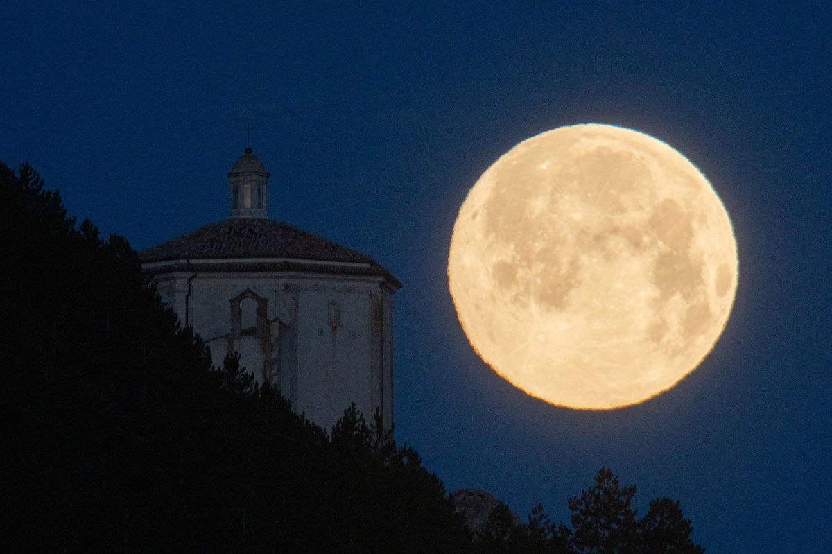 Nicknamed the snow moon, the golden orb will appear almost like any ordinary full moon. Here, the snow moon looms in the sky over Abruzzo, Italy, in February 2022.