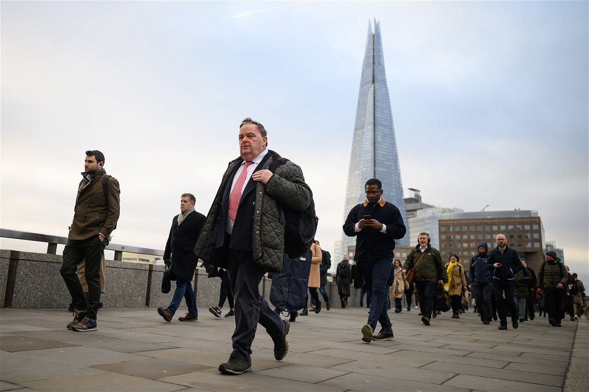 Commuters cross London Bridge during the morning rush hour on January 31, 2023, in London.