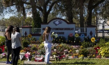 People visit a memorial at Marjory Stoneman Douglas High School to honor those killed on the 5th anniversary of the mass shooting on February 14