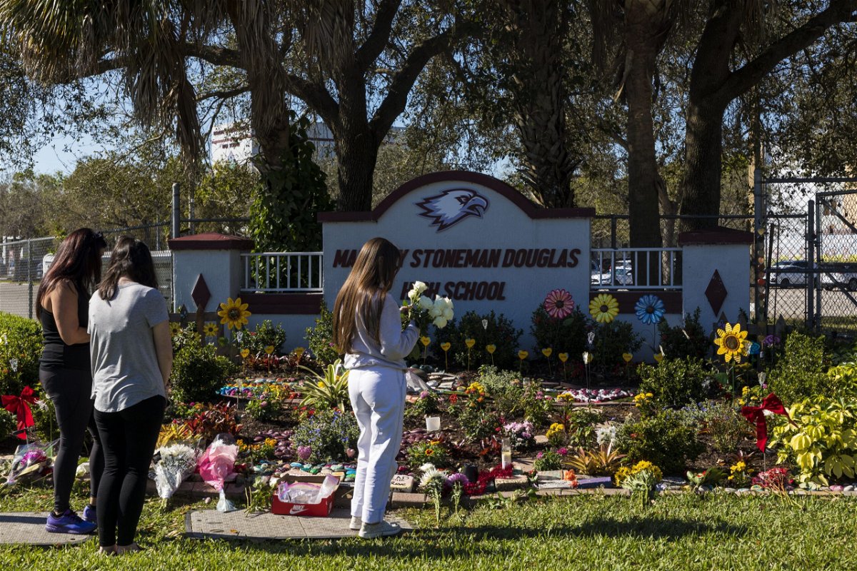 <i>Saul Martinez/Getty Images/File</i><br/>People visit a memorial at Marjory Stoneman Douglas High School to honor those killed on the 5th anniversary of the mass shooting on February 14