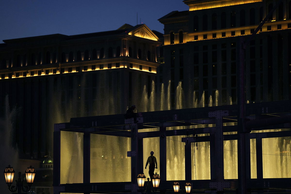 A construction worker helps build a grandstand in front of the fountains at Bellagio hotel-casino along the Las Vegas Strip ahead of the Las Vegas Formula One Grand Prix auto race in September 2023.