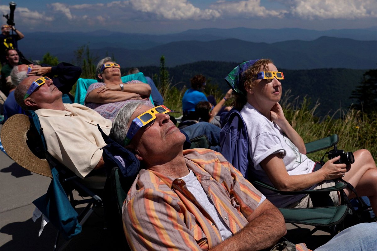People watch as the August 2017 solar eclipse approaches totality in Great Smoky Mountains National Park in Tennessee. Clear skies will likely be harder to find for this year's eclipse in April.	