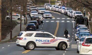 Police are shown near the scene where three police officers were shot Wednesday in Washington