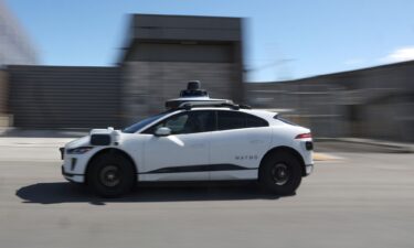 A Waymo Jaguar I-Pace drives along a street on March 01