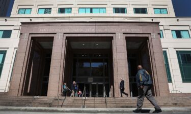 A member of the US Marshals Service walks in front of the federal district court in Miami