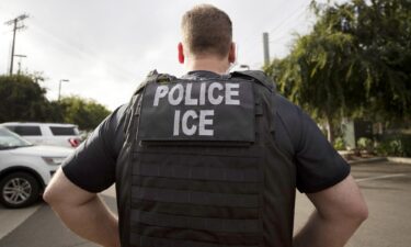 A U.S. Immigration and Customs Enforcement (ICE) officer looks on during an operation in Escondido