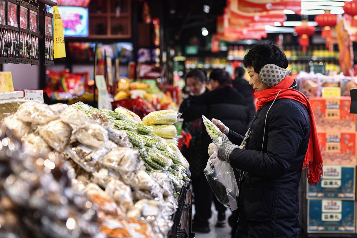 Customers shop for vegetables and fruit at a supermarket in Fuyang, China, on February 8, 2024.