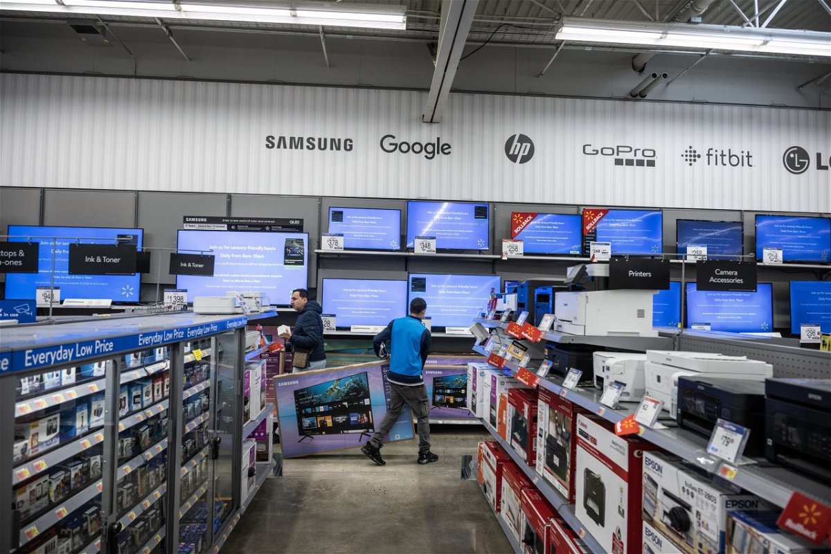 <i>Victor J. Blue/Bloomberg/Getty Images</i><br/>A worker stocks televisions at a Walmart store on Black Friday in Secaucus