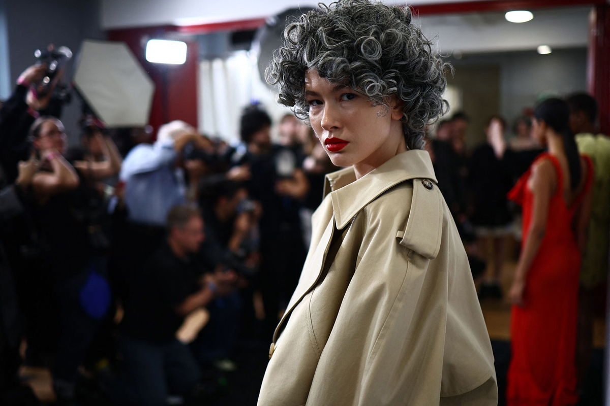 <i>Henry Nicholls/AFP/Getty Images</i><br/>Salt and pepper permed wigs were paired with a striking red lip.