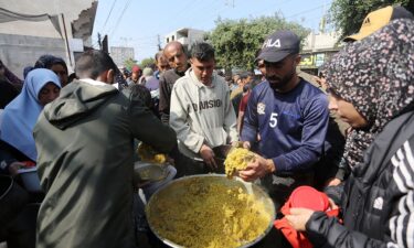 Palestinians wait in lines for several hours to receive food from charity organizations as they struggle to find food amid Israeli attacks in Deir al-Balah on February 27.