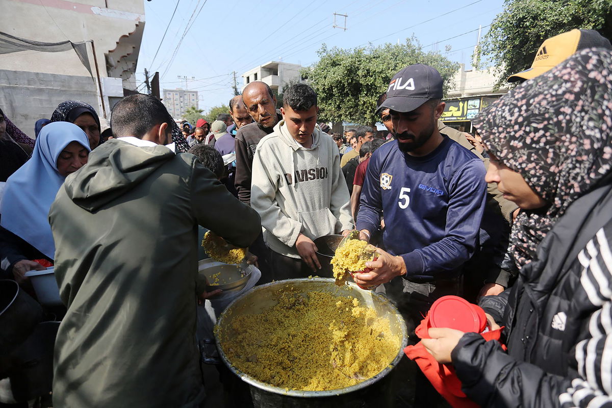 <i>Ashraf Amra/Anadolu/Getty Images via CNN Newsource</i><br/>Palestinians wait in lines for several hours to receive food from charity organizations as they struggle to find food amid Israeli attacks in Deir al-Balah on February 27.