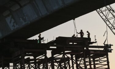 Laborers work at a construction site in Mumbai in November 2023.