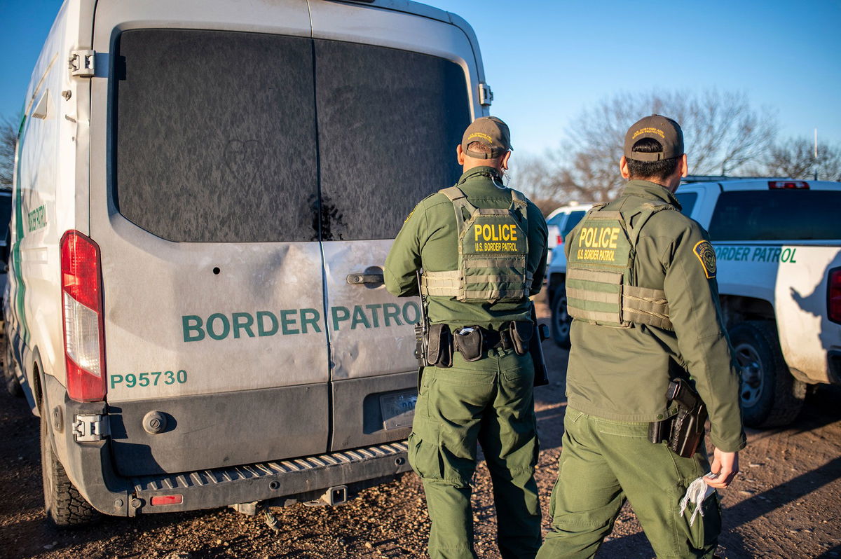 <i>Sergio Flores/AFP/Getty Images via CNN Newsource</i><br/>A federal judge suspended a controversial law that allowed state law enforcement agents to arrest and detain people they suspect of entering the country illegally. Border Patrol officers are shown here processing a group of about 60 migrants near the highway on February 4