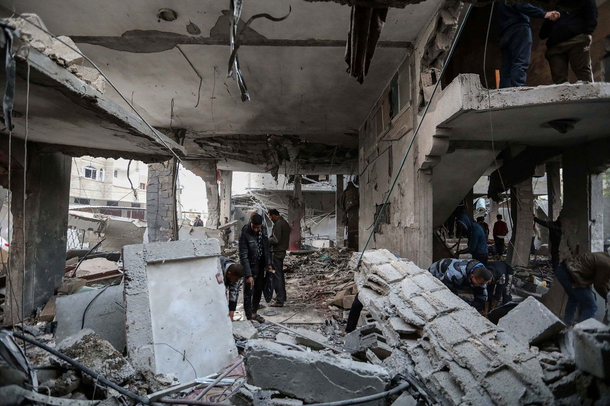 <i>Ahmad Hasaballah/Getty Images via CNN Newsource</i><br/>People inspect damage to their homes following Israeli air strikes on February 24