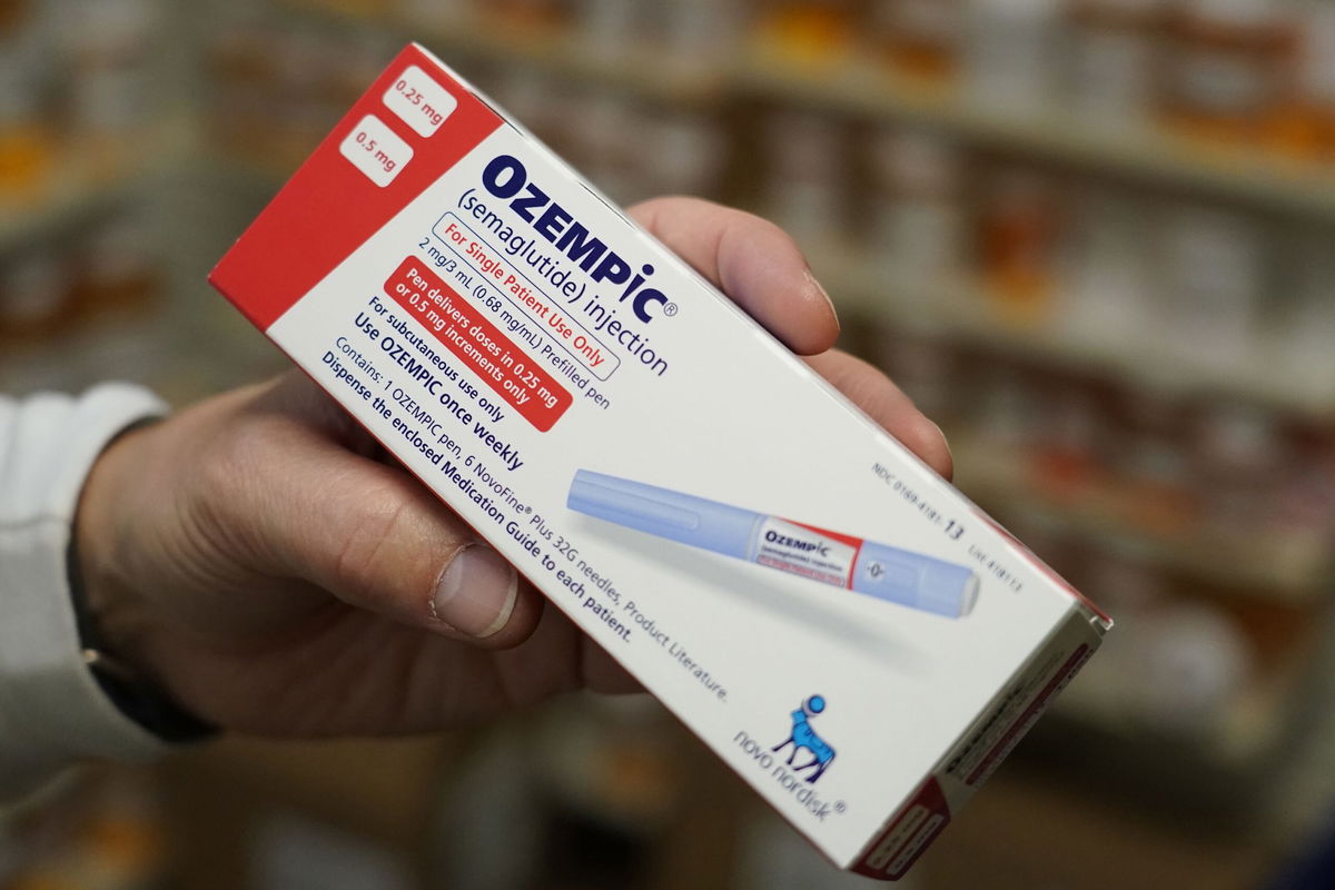 Goldman Sachs predicts drugs like Ozempic could strengthen the US economy, seen here, a pharmacist holds a box of Novo Nordisk A/S Ozempic brand semaglutide medication arranged at a pharmacy in Provo, Utah, US, in November 2023.