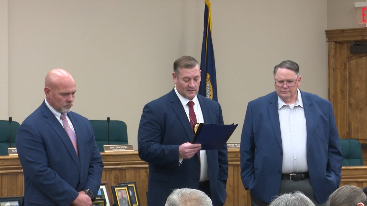 Police Chief Joshua Rhodes (center) shares his thought during a retirement ceremony for  Det. Randy Reese (right)  and Sgt. Dave Stubbs (left).