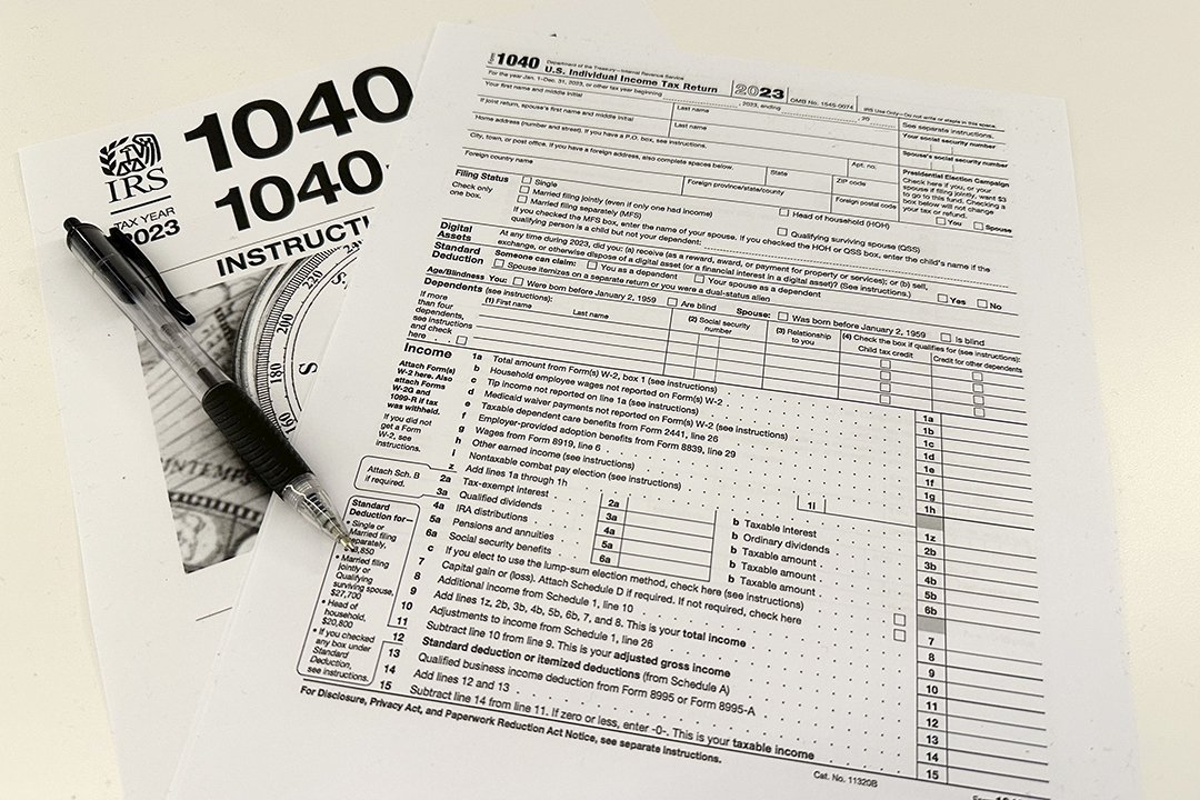 FILE - An Internal Revenue Service 2023 1040 tax form and instructions are shown on Jan. 26, 2024 in New York. It's tax season in the U.S., and for many people, filing tax returns can be a daunting task that's often left until the last minute.