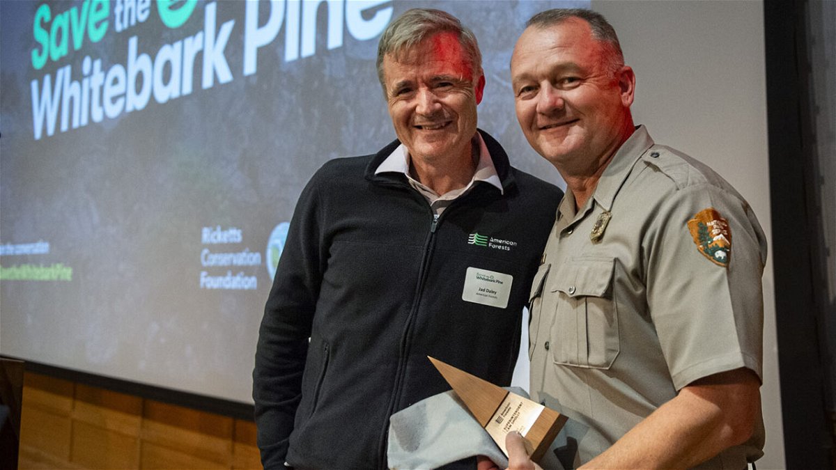 Jad Daley, President and CEO of American Forests, left, gives Cam Sholly, Superintendent of Yellowstone National Park, an award at the Museum of the Rockies on Thursday, Sept. 28, 2023, in Bozeman, Mont.