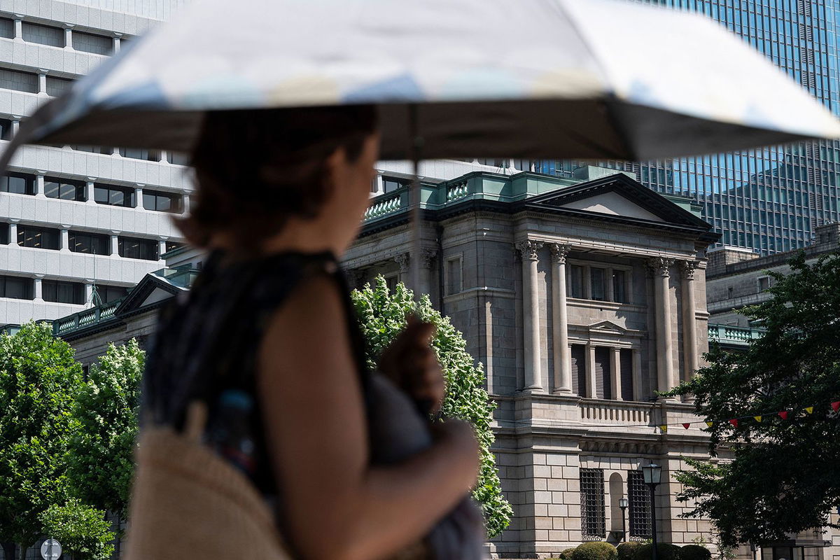 A pedestrian walks past the Bank of Japan building in Tokyo. Japan has ended its negative interest rate policy.