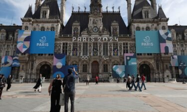 The Paris 2024 logo is displayed on the façade of the Paris town hall. Organizers of the Olympic Games will offer free condoms