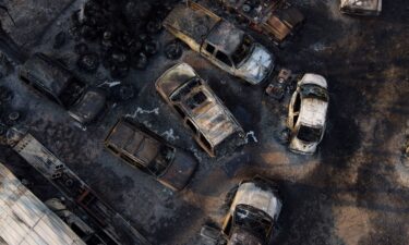 Charred vehicles sit at an auto body shop after the property was burned by the Smokehouse Creek Fire on Wednesday