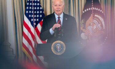 President Joe Biden talks with Delaware Gov. John Carney following a dinner reception for governors and their spouses on February 11 in Washington