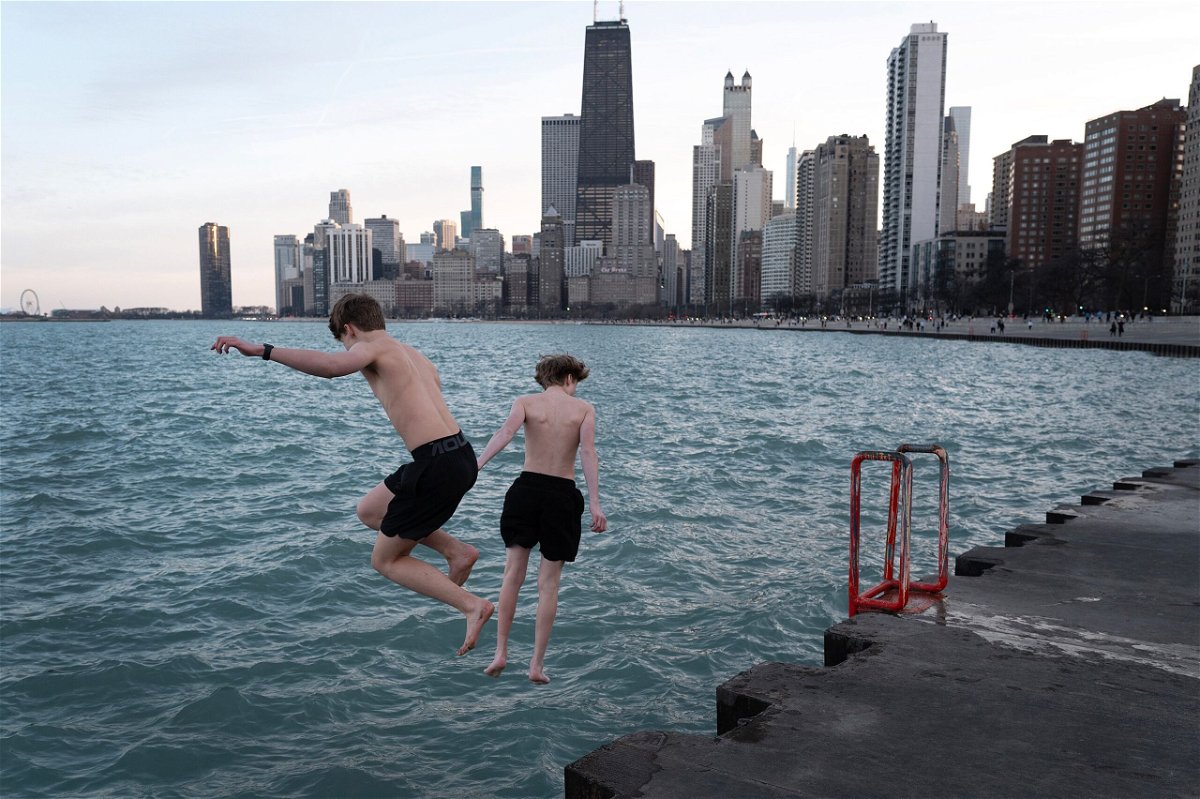 <i>Scott Olson/Getty Images via CNN Newsource</i><br/>Kids jump into Lake Michigan during unseasonably warm conditions in Chicago on February 26.
