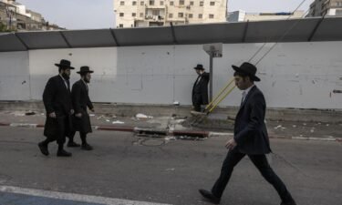 Ultra-Orthodox Jewish men walk in the central Israeli city of Bnei Brak on February 27.