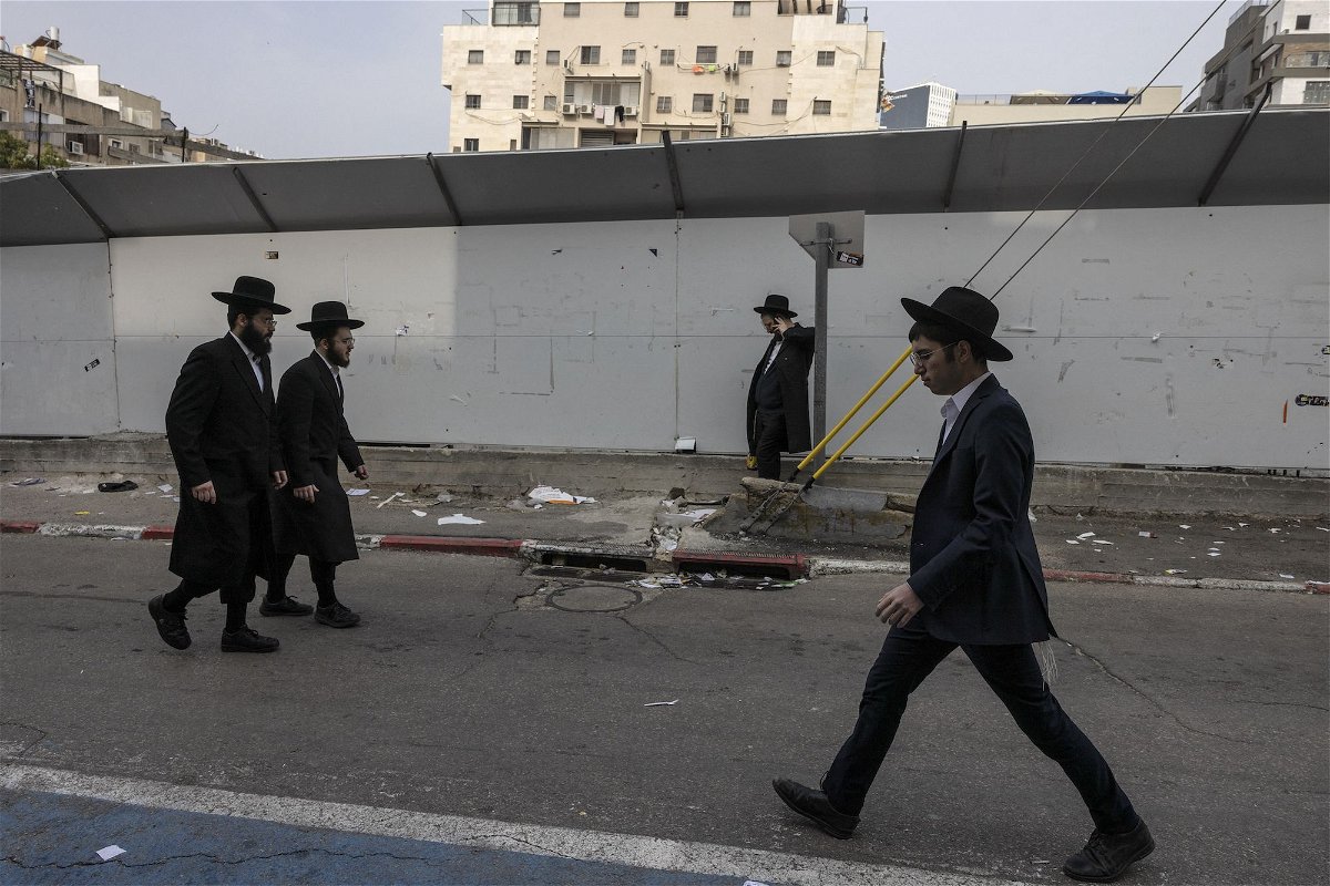 <i>Menahem Kahana/AFP/Getty Images via CNN Newsource</i><br/>Ultra-Orthodox Jewish men walk in the central Israeli city of Bnei Brak on February 27.